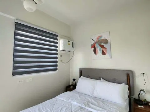 A small bright bedroom with a double bed